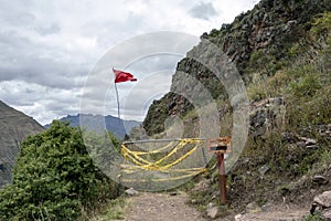 Landscape with green Andean Mountains and Inca ruins on the hiking path in Pisac archeological park, Peru