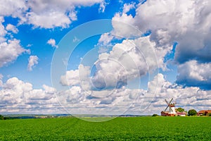 Landscape with green grass and windmill
