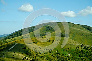 Landscape with green hill in summer and blue sky.