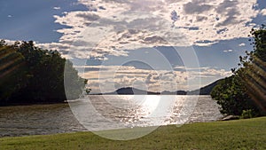 Landscape of green nature park with lake in sunny day and white cloud. Relax time