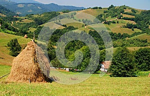 Landscape with haystack and house