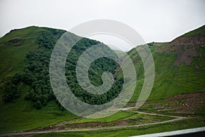 Landscape high mountains in dense fog tops of mountains in clouds North Caucasus Elbrus