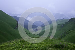 Landscape high mountains in dense fog tops of mountains in clouds North Caucasus Elbrus