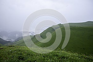 Landscape high mountains in dense fog tops of mountains in clouds North Caucasus Elbrus