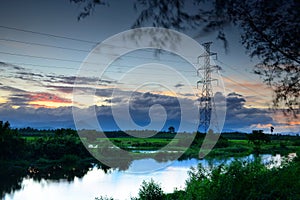 Landscape high voltage post at sunset