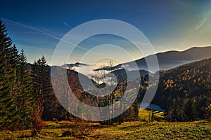 landscape of hiking paradise Schneeberg with grass, hills, authumn forest, blue sky and clouds