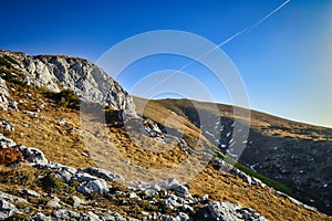 landscape of hiking paradise Schneeberg, mountain peak with mountain, rocks, clouds, and blue sky