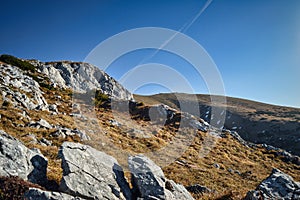 landscape of hiking paradise Schneeberg, mountain peak with mountain, rocks, clouds, and blue sky