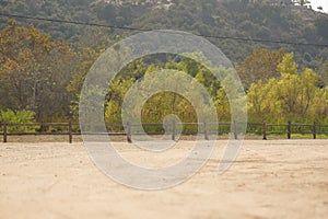 Landscape of a hiking trail with wooden fences, a montane forest in the background in San Diego, US