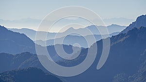 Landscape on hills and Alps mountains with humidity in the air and pollution