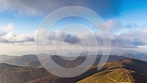 Landscape of hills forestry slopes under sky with clouds