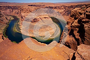 Landscape of Horseshoe Bend with sunrise and reflecting surface of Colorado River near Grand Canyon.