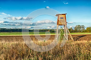 Landscape with hunting lodge in middle of meadow amazing blue sky with clouds