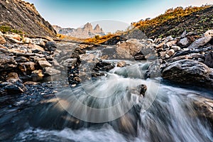 Landscape of iconic three peak and waterfall flowing of Aiguilles d\'Arves in French alps at Savoie, France