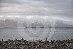 Landscape image of a of blue sea with mountains and volcanos