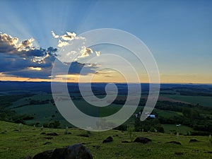 Sunset Landscape with Dramatic Clouds and Rolling Fields