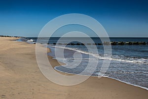 Landscape image of the jetty on the shoreline at Rehoboth Beach, Delaware