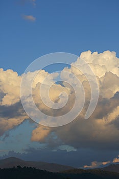 Landscape image, large cloud on sky above mountain hill