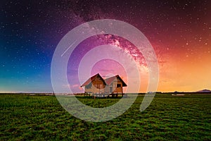 Landscape image of milky way over the abandoned twin house near Chalerm Phra Kiat road in Thale Noi, Phatthalung, Thailand