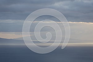 Landscape image showing cloud layers over Faial island as seen from Sao Jorge Island, Azores photo