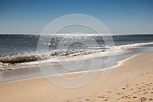 Landscape image of the sparkling water on the shoreline of Rehoboth Beach, Delaware in the middle of the morning..