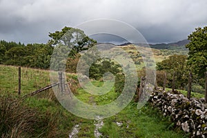 Landscape image of view from Precipice Walk in Snowdonia overlooking Barmouth and Coed-y-Brenin forest during rainy afternoon in