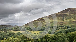 Landscape image of view from Precipice Walk in Snowdonia overlooking Barmouth and Coed-y-Brenin forest during rainy afternoon in