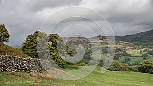 Landscape image of view from Precipice Walk in Snowdonia overlooking Barmouth and Coed-y-Brenin forest during rainy afternoon in