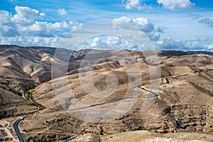 Landscape of Israel desert. Blue Cloudy Sky and road in background. Mountain. Judaean Desert. Cloudy Blue Sky