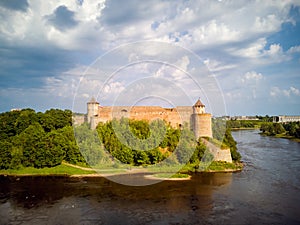 Landscape with Ivangorod Castle on a cloudy and sunny day