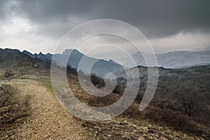 Landscape of Karadag Reserve in spring. View of mountains in fog and clouds. Crimea