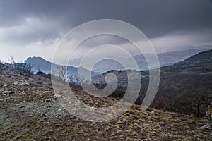 Landscape of Karadag Reserve in spring. View of mountains in fog and clouds. Crimea