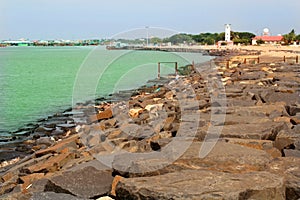 Landscape of karaikal beach with stone way and light house.