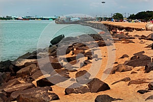 A landscape of the karaikal beach with stone way and light house.