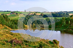 Landscape lake in the distance, lake and picturesque forest and field in the distance