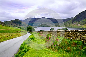 Landscape in the lake district, England. Nature view with a stile and stone wall in the foreground. Lake District Valley