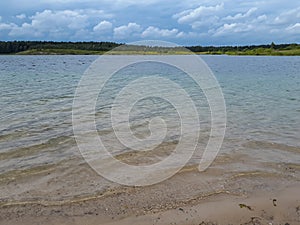 Landscape of lake and forest in the far and texture of crystal clear light Blue, green and turquoise transparent water with fine