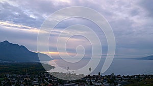 Landscape of lake, mountain and city. Panoramic view of Lake Geneva and Villeneuve city at sunset.