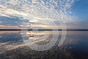 Landscape with lake reflection clouds. Beautiful summer sunset