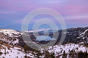 Landscape of Lake Tahoe surrounded by a snowy field during the sunset in the US