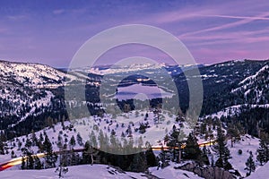 Landscape of Lake Tahoe surrounded by a snowy field during the sunset in the US