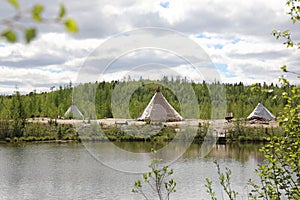 Landscape with a lake and the tents of Nenets in Northern Siberia