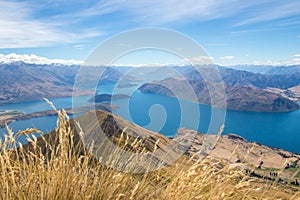 Landscape of lake Wanaka captured from Roys peak track in new zealand with grass in the forground