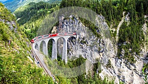 Landscape with Landwasser Viaduct in summer, Filisur, Switzerland. Rhaetian glacier express runs on amazing railway photo