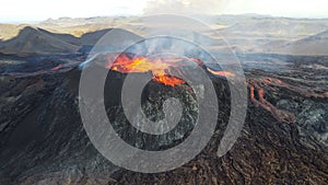 Landscape of lightening erupting Mauna Loa Volcano in Hawaii with smoke and hazy sky