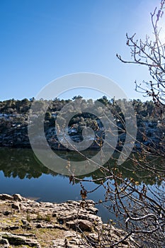 Landscape of the Lozoya river with the reflection of the trees reflected in the water. photo