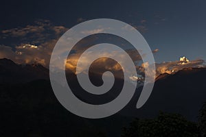 Landscape with Machapuchare-Fishtail peak at sunset view from Ghandruk during trekking in Himalaya Mountains, Nepal photo