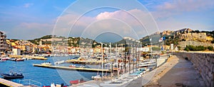 Landscape with marina in harbour of Cassis resort town at sunset. France, Provence