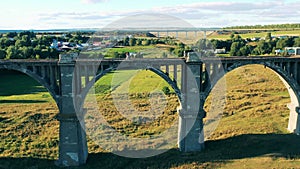 Landscape with a massive bridge and a lady on it