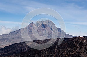 Landscape of the Mawenzi Peak of Mount Kilimanjaro under sunlight with shadow in front